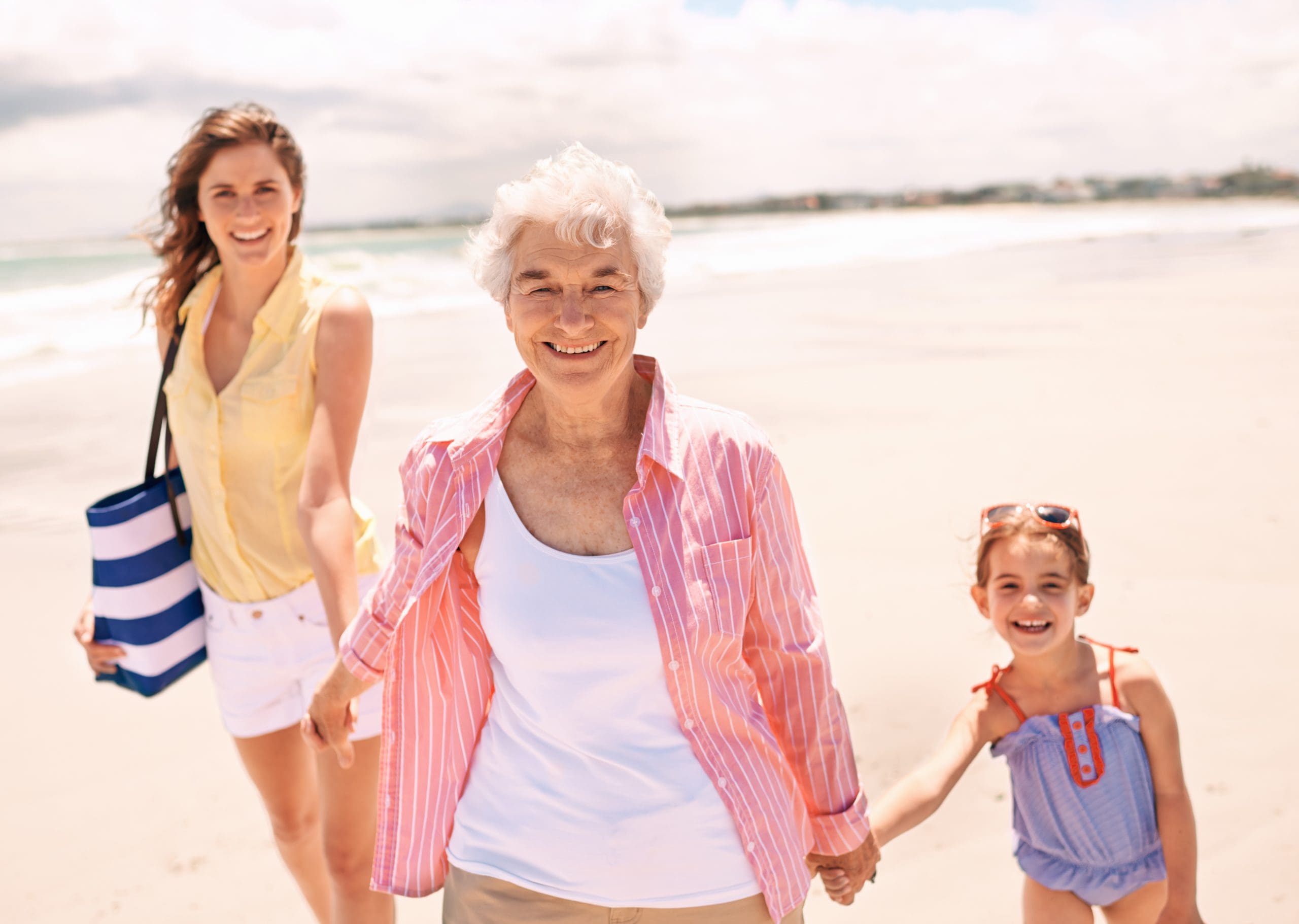 Three generations of a family—grandparent, parent, and child—spending time together, representing the Sandwich Generation experience.