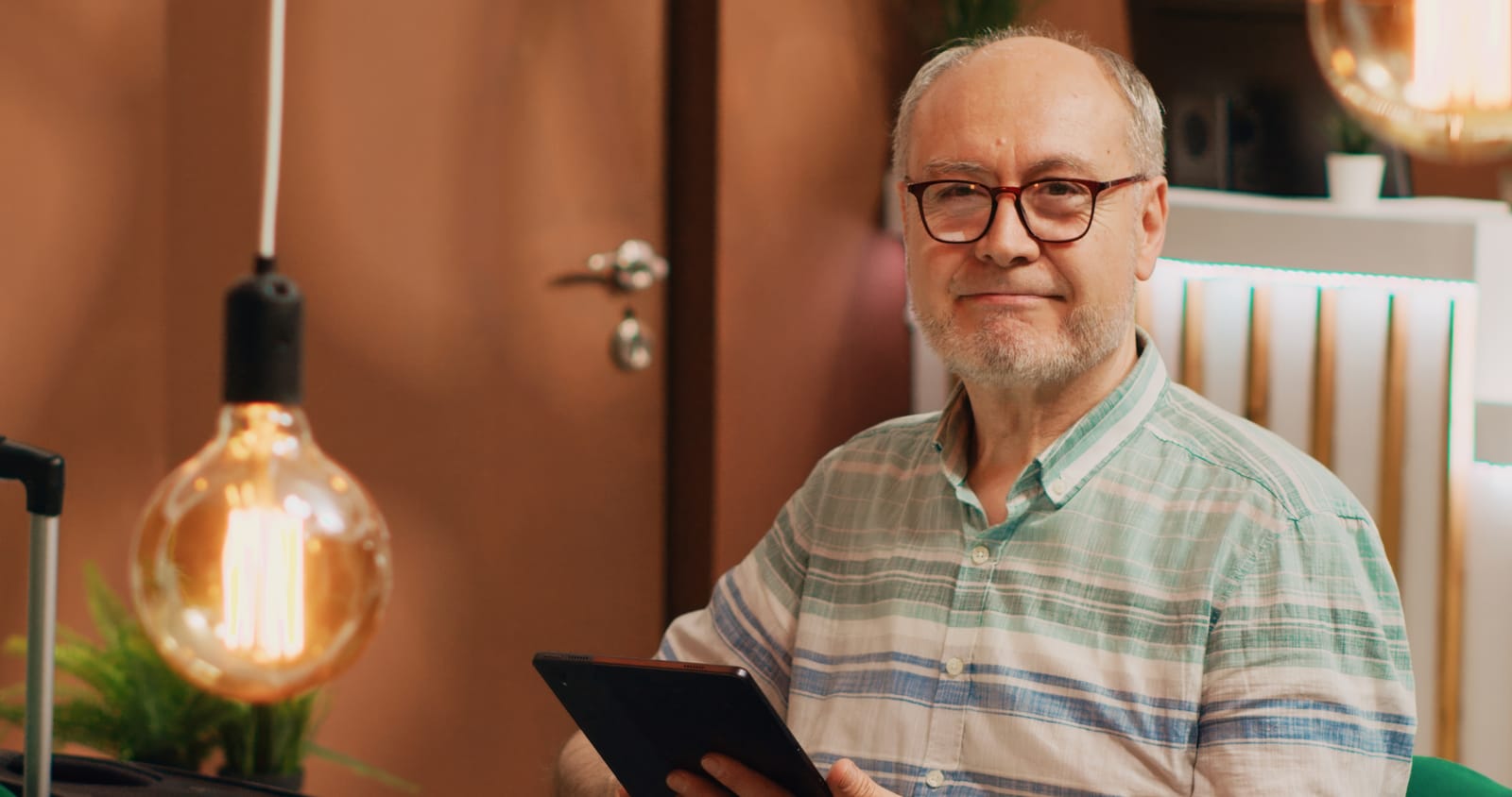 Older man smiling while sitting in chair