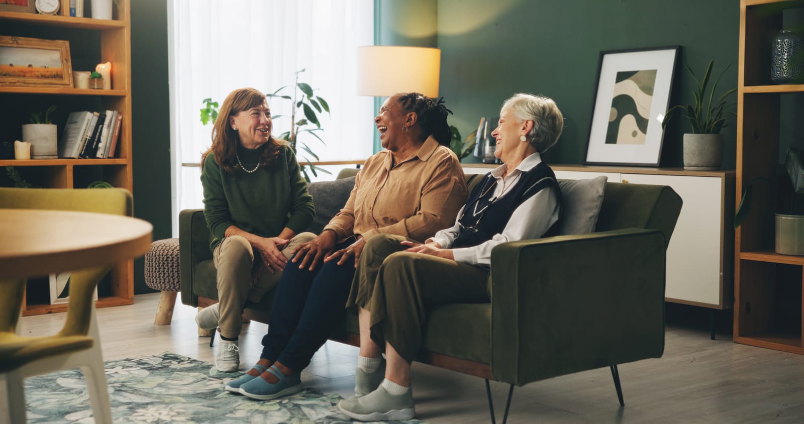 Elderly woman sitting on couch who are part of a caregiver community support group