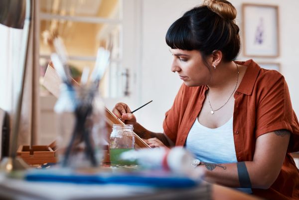 woman reconnecting with yourself beyond caregiving by spending time painting