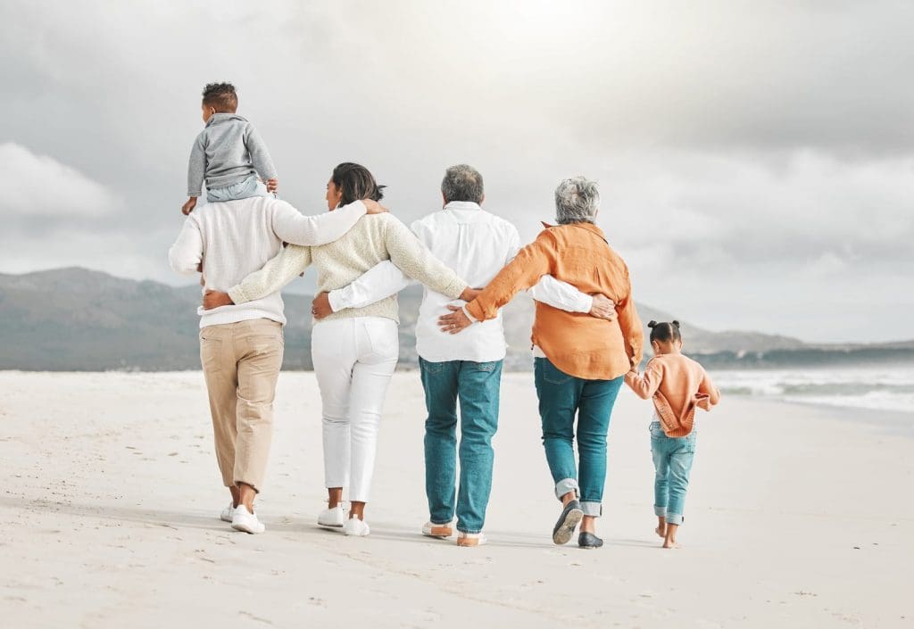 family in the sandwich generation walking on beach