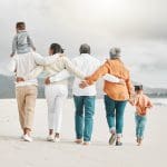 family in the sandwich generation walking on beach