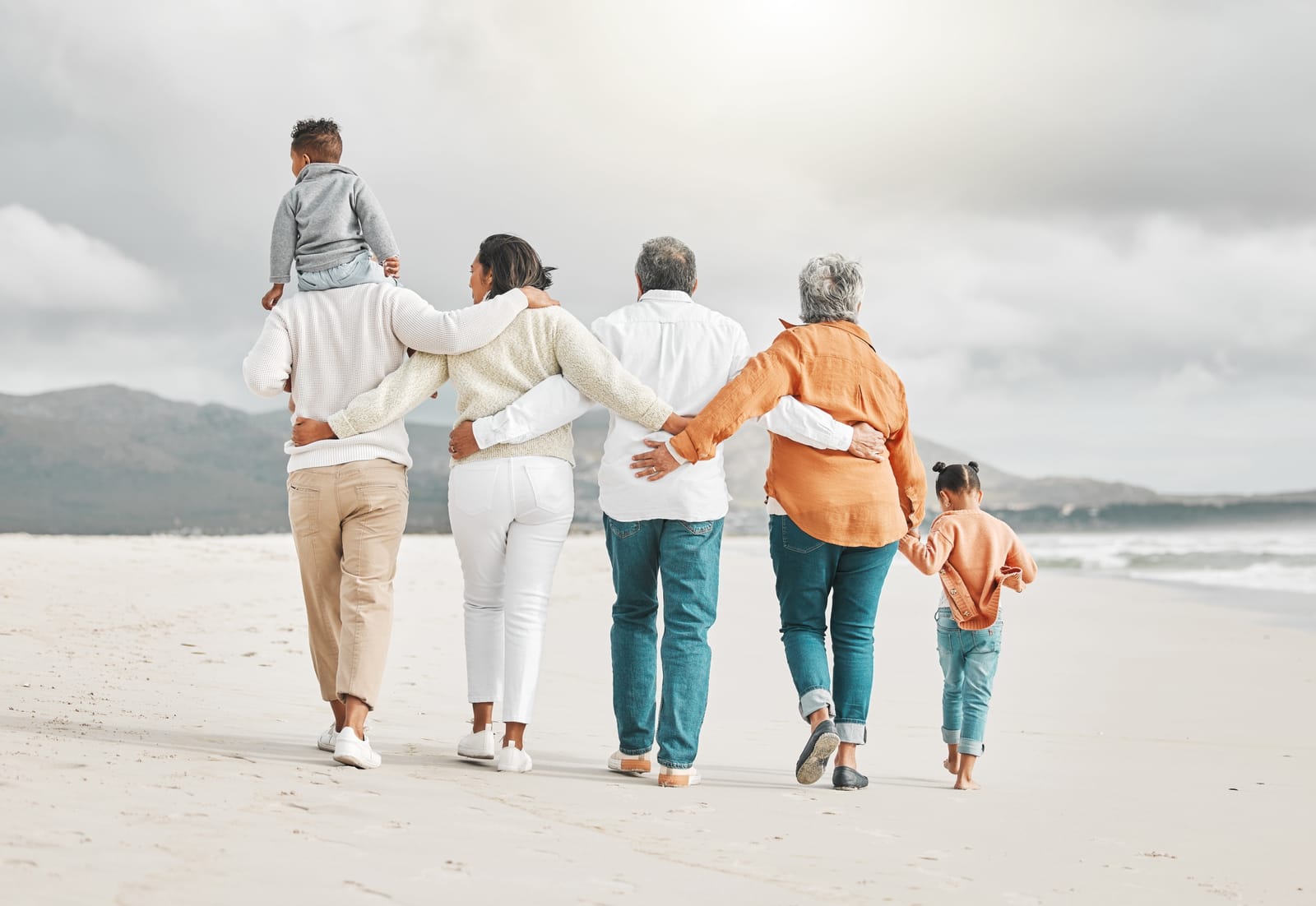 family in the sandwich generation walking on beach