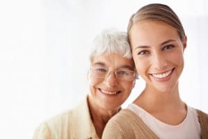 smiling senior mother with daughter who is a sandwich generation caregiver