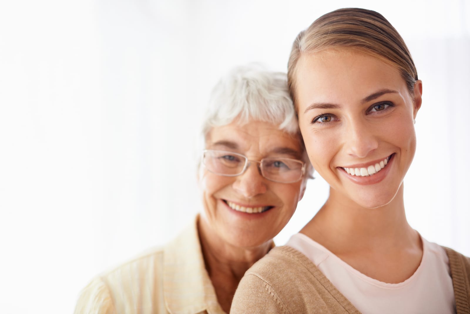 smiling senior mother with daughter who is a sandwich generation caregiver